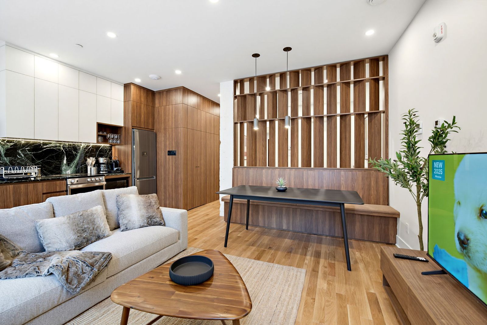 Living and dining space with sectional sofa and pendant lights