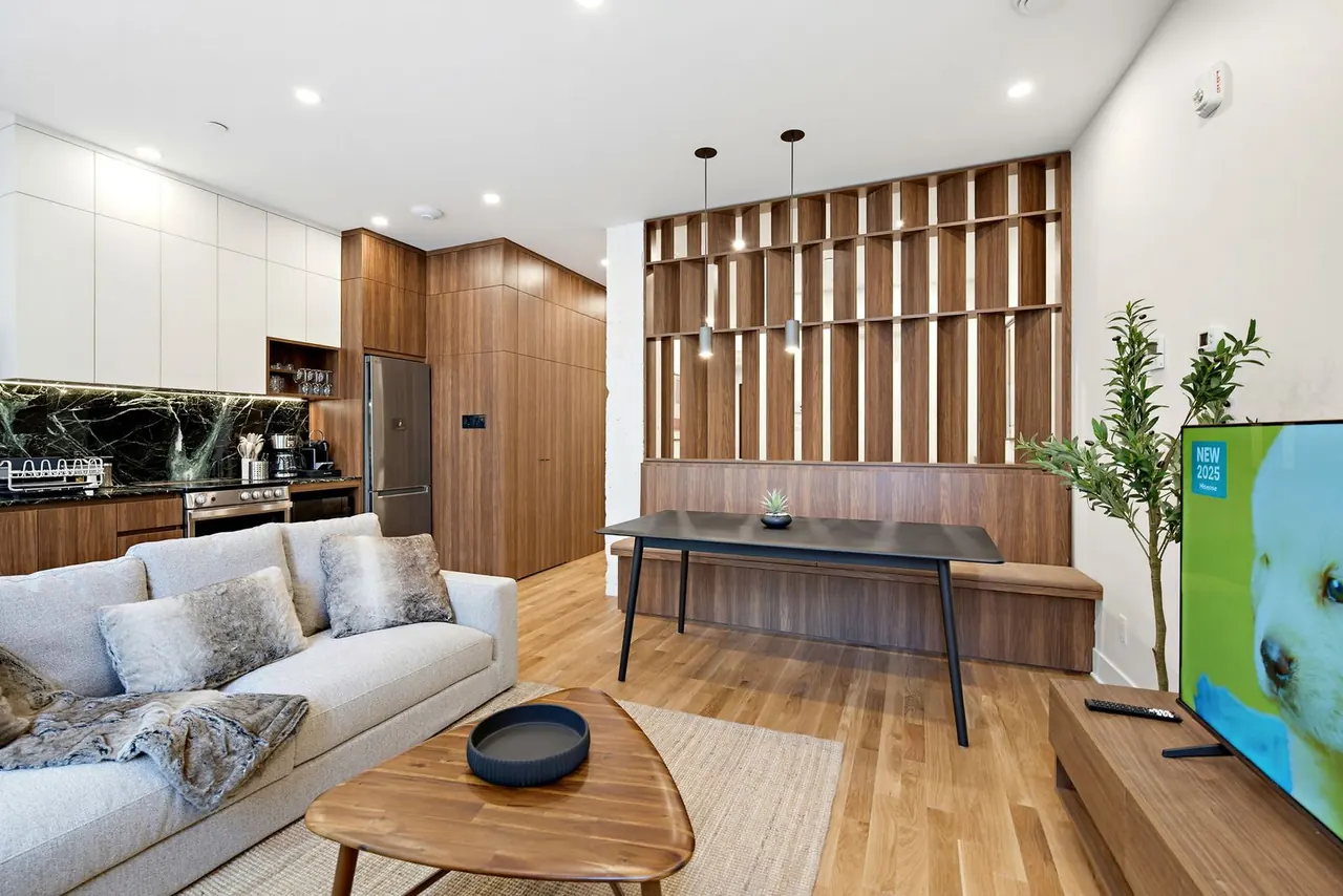 Living and dining space with sectional sofa and pendant lights